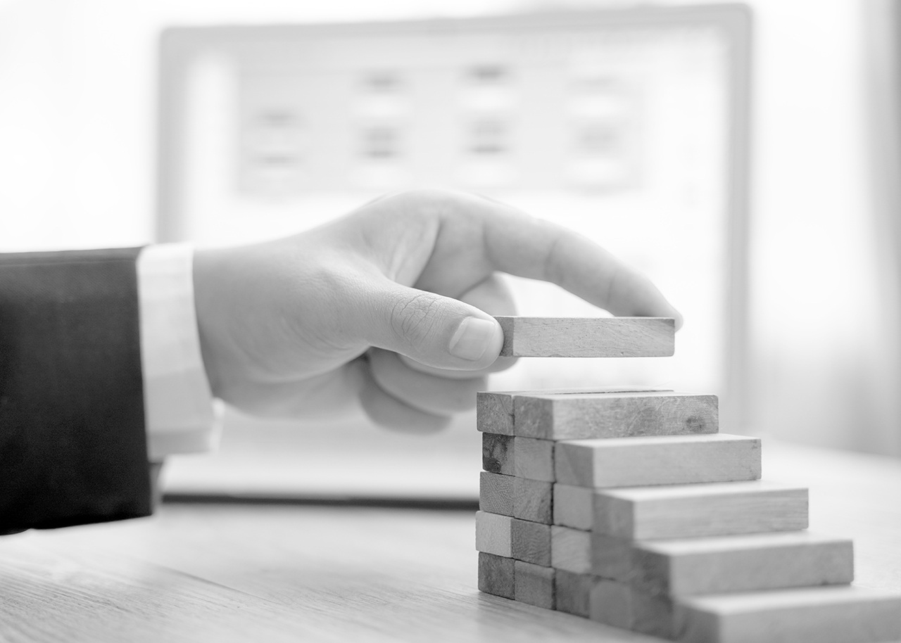 Business man's hand stacking blocks